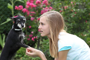 Image showing Young girl with her little dog