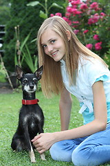 Image showing Smiling teenage girl with her dog