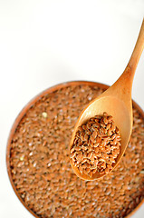 Image showing close up of flax seeds and wooden spoon