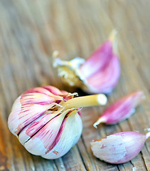 Image showing red garlic bulb on old wood