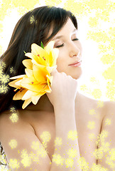 Image showing brunette with yellow flowers in spa