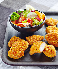 Image showing chicken nuggets and fresh vegetable salad