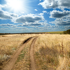 Image showing sun and clouds over rural road