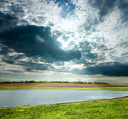 Image showing view to overcast landscape with pond