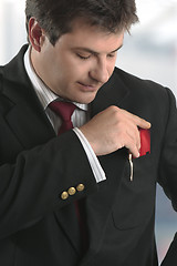 Image showing Man businessman holding credit card or other plastic card