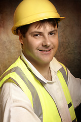Image showing Confident builder in work clothes smiling