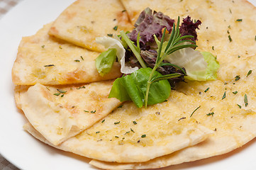 Image showing garlic pita bread pizza with salad on top