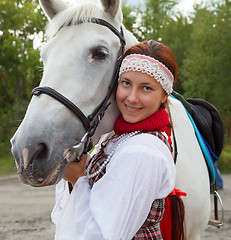 Image showing Portrait of a girl next to a white horse