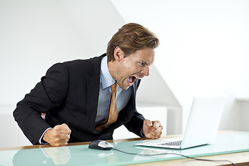 Image showing Frustrated businessman shouting at laptop