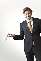 Image showing Playfull businessman holding paper airplane