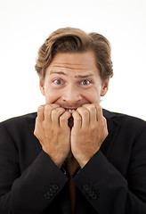 Image showing Businessman chewing on his fingernails with a worried expression