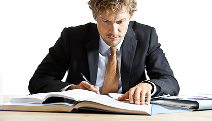 Image showing Concentrated businessman working at desk