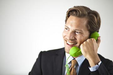 Image showing Smiling businessman talking on the phone