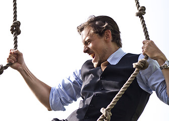 Image showing Strong, able businessman climbing ropes