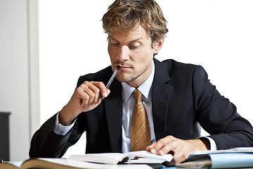 Image showing Businessman trying to figure out the work