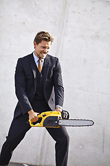 Image showing Crazy businessman with a chainsaw