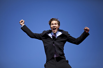 Image showing Excited businessman jumping