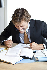 Image showing Angry businessman at desk