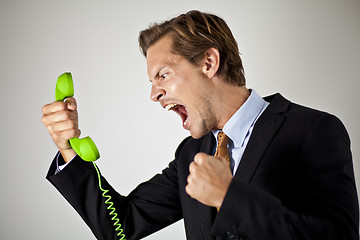 Image showing Businessman screaming at phone