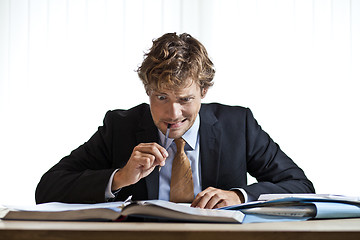 Image showing Perplexed businessman working on problem