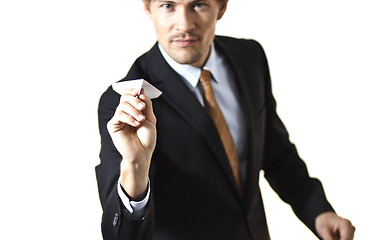 Image showing Businessman getting ready to throw paper airplane