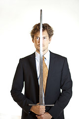 Image showing Silent businessman holding sword