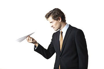 Image showing Concentrated businessman looking at paper airplane