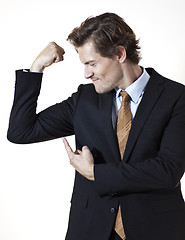 Image showing Businessman showing off mucsles