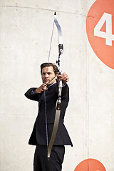 Image showing Businessman aiming bow and arrow