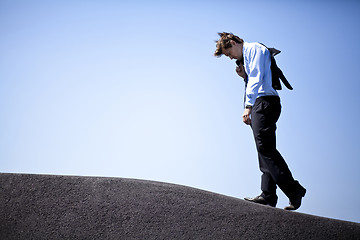 Image showing Businessman climbing a hill