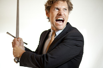 Image showing Crazy businessman attacking with a sword