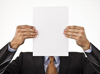 Image showing Businessman holding white paper in front of his face