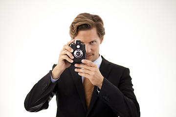 Image showing Businessman holding old camera