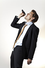 Image showing Drinking businessman