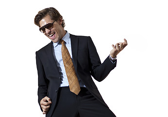 Image showing Cool businessman playing air guitar