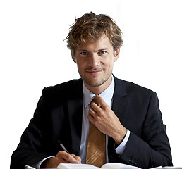 Image showing Businessman adjusting his tie smiling