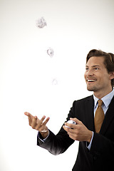 Image showing Accomplished businessman juggling paper