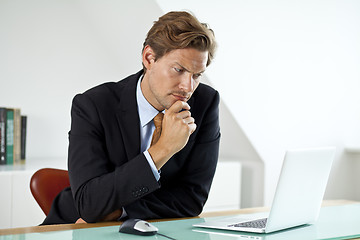 Image showing Concerned Businessman in front of laptop