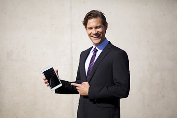 Image showing Businessman pointing at tablet