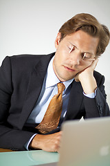 Image showing Sleepy businessman trying to stay awake