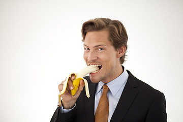 Image showing Healthy businessman eating banana