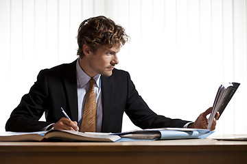 Image showing Hardworking businessman reading book