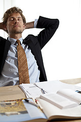 Image showing Tired businessman falling asleep at work