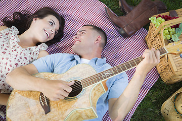 Image showing Mixed Race Couple at the Park Playing Guitar and Singing