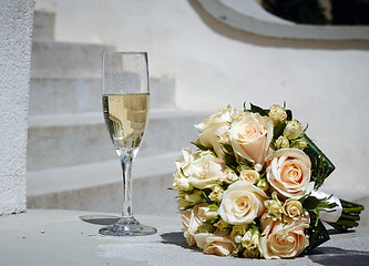 Image showing wedding bouquet and glass of champagne