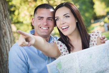 Image showing Mixed Race Couple Looking Over Map Outside Together