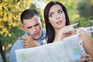 Image showing Lost and Confused Mixed Race Couple Looking Over Map Outside