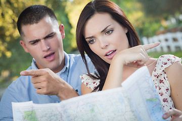 Image showing Lost and Confused Mixed Race Couple Looking Over Map Outside