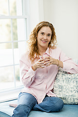 Image showing Woman relaxing by the window