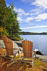 Image showing Adirondack chairs at lake shore